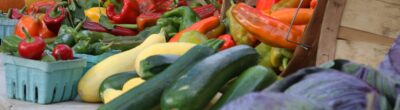 Peppers, squash, zucchini, cabbages, and pumpkins on a table